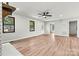 Light-filled living room with wood-look flooring and two windows at 3372 Lee Lawing Rd, Lincolnton, NC 28092