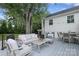 Back deck with ample seating and an outdoor dining set for entertaining at 4126 Tyndale Ave, Charlotte, NC 28210