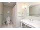Vintage style bathroom featuring a traditional sink, toilet, and shower with floral curtain at 4126 Tyndale Ave, Charlotte, NC 28210