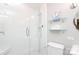 Bright bathroom featuring a glass shower, modern fixtures, and a glass shelving unit at 4126 Tyndale Ave, Charlotte, NC 28210