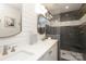 Modern bathroom with double vanity, quartz countertop, and glass-enclosed walk-in shower with gray tiling at 4126 Tyndale Ave, Charlotte, NC 28210