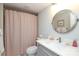 This bathroom has a toilet, vanity, mirror, white countertops, and a shower with a patterned curtain at 4126 Tyndale Ave, Charlotte, NC 28210