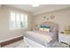 Cozy bedroom features a queen-sized bed with decorative pillows and a large window with plantation shutters at 4126 Tyndale Ave, Charlotte, NC 28210