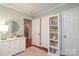 A well-lit room featuring a dresser, a shelf with books, and a view through a doorway at 4126 Tyndale Ave, Charlotte, NC 28210