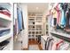 Walk-in closet with custom shelving, hardwood floors, and ample storage for clothing and accessories at 4126 Tyndale Ave, Charlotte, NC 28210
