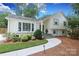 Beautiful home featuring a winding walkway, mature landscaping, and classic architectural details at 4126 Tyndale Ave, Charlotte, NC 28210