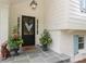 Close up of the entryway showcasing a stylish door, potted plants, and stone porch at 4126 Tyndale Ave, Charlotte, NC 28210