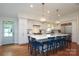 Modern kitchen with white cabinets, a large island, and stainless steel appliances, ideal for cooking at 4126 Tyndale Ave, Charlotte, NC 28210