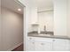Laundry room with white cabinets and sink. A hallway can be seen on the side of the room at 4126 Tyndale Ave, Charlotte, NC 28210
