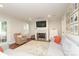 Bright living room with a fireplace, stylish furniture, and access to the backyard at 4126 Tyndale Ave, Charlotte, NC 28210