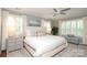 Serene main bedroom with neutral tones, a ceiling fan, and bright natural light from the many windows at 4126 Tyndale Ave, Charlotte, NC 28210