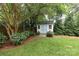 Charming backyard shed with blue doors and surrounding hydrangeas at 4126 Tyndale Ave, Charlotte, NC 28210
