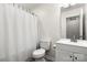 Bathroom featuring white sink, toilet, and shower with white curtain at 4209 Grier St, Gastonia, NC 28056