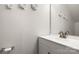 Neutral bathroom features white vanity with decorative flower art on the wall at 4209 Grier St, Gastonia, NC 28056