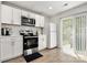 Bright kitchen featuring modern appliances, white cabinets, and sliding glass doors at 4209 Grier St, Gastonia, NC 28056