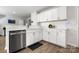 Bright kitchen featuring white cabinets, subway tile backsplash, and stainless steel dishwasher at 4209 Grier St, Gastonia, NC 28056
