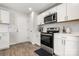 Stylish kitchen with white cabinets, stainless steel appliances, and modern finishes at 4209 Grier St, Gastonia, NC 28056