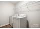 A clean laundry room features a washer, dryer, and wire shelving for storage at 4209 Grier St, Gastonia, NC 28056