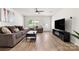 Sun-filled living area featuring stylish furniture, a ceiling fan, and seamless wood floors at 4209 Grier St, Gastonia, NC 28056