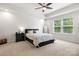 Bright bedroom featuring a ceiling fan, carpet, and large window at 4209 Grier St, Gastonia, NC 28056