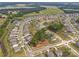Aerial view of a neighborhood featuring tree-lined streets, a pond, and verdant landscaping at 4427 Poplin Grove Dr, Indian Trail, NC 28079