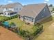 A large fenced backyard featuring a patio and various landscaping features, creating a serene outdoor space at 4427 Poplin Grove Dr, Indian Trail, NC 28079