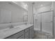 Bathroom with double sink vanity, framed mirror, and glass shower at 4427 Poplin Grove Dr, Indian Trail, NC 28079