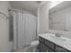 Bright bathroom featuring a shower with patterned curtain, single sink vanity and large mirror at 4427 Poplin Grove Dr, Indian Trail, NC 28079