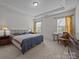 Spacious bedroom featuring 2 windows, carpet, side tables, and furniture at 4427 Poplin Grove Dr, Indian Trail, NC 28079
