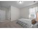 Bright bedroom with a comfortable bed and natural light from the window at 4427 Poplin Grove Dr, Indian Trail, NC 28079