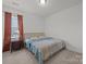 Bedroom features a cozy bed, a window with blinds, and neutral carpet at 4427 Poplin Grove Dr, Indian Trail, NC 28079