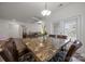 Dining area featuring a large table with seating for eight, leading into an open living space at 4427 Poplin Grove Dr, Indian Trail, NC 28079