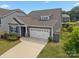 Well-maintained home featuring a two-car garage and manicured lawn, situated on a lovely lot at 4427 Poplin Grove Dr, Indian Trail, NC 28079
