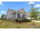Charming home featuring a two-car garage, stone accents, manicured lawn, and mature trees at 4427 Poplin Grove Dr, Indian Trail, NC 28079