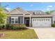 Charming home featuring a two-car garage, stone accents, manicured lawn, and delightful red roses at 4427 Poplin Grove Dr, Indian Trail, NC 28079