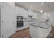 Modern kitchen with stainless steel appliances, double ovens, granite countertops and white cabinets at 4427 Poplin Grove Dr, Indian Trail, NC 28079