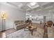 Open concept living room with fireplace and coffered ceilings, seamlessly connected to the kitchen at 4427 Poplin Grove Dr, Indian Trail, NC 28079