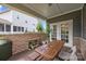 View of the covered patio featuring a wooden table, chairs, and a brick wall at 4427 Poplin Grove Dr, Indian Trail, NC 28079