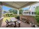 Covered patio with outdoor seating, brick accent wall, and views of the landscaped backyard at 4427 Poplin Grove Dr, Indian Trail, NC 28079