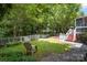 Spacious backyard featuring a grassy area, sitting area and wooded background at 4439 Brandie Glen Rd, Charlotte, NC 28269