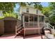 Enjoy outdoor living on this wooden deck with a screened in porch and stairs leading down to a patio area at 4439 Brandie Glen Rd, Charlotte, NC 28269