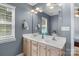 Bright bathroom with double sink vanity, large mirror, and modern fixtures at 4439 Brandie Glen Rd, Charlotte, NC 28269
