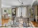 Elegant dining area with modern table, stylish chairs, large rug, and natural light, perfect for entertaining guests at 4439 Brandie Glen Rd, Charlotte, NC 28269