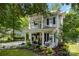 Charming two-story home with a front porch, balcony, blue shutters, a well manicured yard, and lush green trees at 4439 Brandie Glen Rd, Charlotte, NC 28269