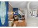 Warm and inviting foyer with wood flooring, stylish furnishings, blue accent wall, and open view to the living spaces at 4439 Brandie Glen Rd, Charlotte, NC 28269