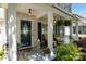 Inviting front porch with comfortable seating, hanging plants, and decorative touches, creating a cozy outdoor living space at 4439 Brandie Glen Rd, Charlotte, NC 28269