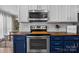 Close-up of kitchen with stainless steel oven and microwave, white subway tile, and ample cabinet space at 4439 Brandie Glen Rd, Charlotte, NC 28269