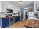 Bright kitchen features stainless steel appliances, blue and white cabinets, and wood countertops at 4439 Brandie Glen Rd, Charlotte, NC 28269