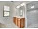 Bathroom with a double vanity, a large mirror, tiled floor, and natural light at 5033 Mockernut Ln, Indian Land, SC 29707
