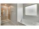 Bathroom featuring a soaking tub, and walk-in shower with glass door at 5033 Mockernut Ln, Indian Land, SC 29707